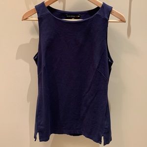 Sleeveless navy top with cut out detail in back.